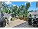 Relaxing back deck with wooden railing and view of trees, backyard, and detached guest house at 1517 Parkwood Ave, Charlotte, NC 28205