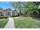 Expansive backyard featuring a fire pit, seating, manicured lawn, and charming landscaping at 1517 Parkwood Ave, Charlotte, NC 28205