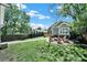 Spacious backyard featuring a fire pit with chairs, green lawn, and walkway to the house at 1517 Parkwood Ave, Charlotte, NC 28205