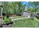 Scenic backyard with fire pit area, chairs, lush lawn, and pathway to a detached guest house at 1517 Parkwood Ave, Charlotte, NC 28205