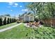 Inviting backyard features a fire pit with chairs, a lush lawn, and a charming gray home exterior at 1517 Parkwood Ave, Charlotte, NC 28205