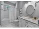 Bright bathroom with granite counters, white cabinets, and a shower/tub combo at 1517 Parkwood Ave, Charlotte, NC 28205