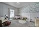 Bedroom with gray carpet, leaf wallpaper, and natural light from the window at 1517 Parkwood Ave, Charlotte, NC 28205