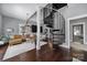 Open-concept living room showcasing a spiral staircase, hardwood floors, and comfortable seating at 1517 Parkwood Ave, Charlotte, NC 28205