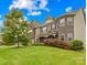 Elegant two-story home with a stone facade, lush landscaping, and a well-maintained front lawn at 15702 Guthrie Dr, Huntersville, NC 28078