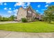 Spacious home boasts a large, landscaped yard, driveway and a mix of stone and traditional siding at 15702 Guthrie Dr, Huntersville, NC 28078