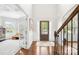 Light-filled foyer with hardwood floors, decorative wainscoting, and views into the adjoining living spaces at 15702 Guthrie Dr, Huntersville, NC 28078