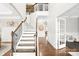 Grand two-story foyer with hardwood floors, elegant staircase, and a view into the adjacent rooms at 15702 Guthrie Dr, Huntersville, NC 28078