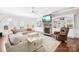 Comfortable living room boasts built-in bookshelves and a cozy stone fireplace at 15702 Guthrie Dr, Huntersville, NC 28078