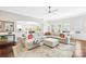 Spacious living room flows to kitchen, featuring a large sectional sofa and open layout at 15702 Guthrie Dr, Huntersville, NC 28078