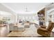 Bright living room features a stone fireplace, hardwood floors, and a large sectional sofa at 15702 Guthrie Dr, Huntersville, NC 28078