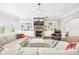 Cozy living room with a large sectional sofa, stone fireplace, and built-in shelving at 15702 Guthrie Dr, Huntersville, NC 28078