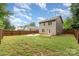 Wide view of the backyard showing the back of the house, a gravel fire pit, and the yard at 1620 Crandon Dr, Charlotte, NC 28216