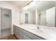 Bathroom featuring double sinks, a large mirror with vanity lighting, and a shower/tub combo at 1620 Crandon Dr, Charlotte, NC 28216