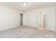 Spacious bedroom featuring neutral carpet, a ceiling light, and access to other rooms at 1620 Crandon Dr, Charlotte, NC 28216