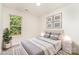 Staged bedroom with modern decor, a comfortable bed, and a bright window with a green view at 1620 Crandon Dr, Charlotte, NC 28216