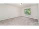 Bright bedroom with a window offering natural light and neutral carpet at 1620 Crandon Dr, Charlotte, NC 28216