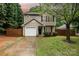 Charming two-story home with a one car garage and a well-manicured lawn at 1620 Crandon Dr, Charlotte, NC 28216