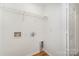 A utility room ready for laundry hookups, featuring wood-look flooring and white walls at 1620 Crandon Dr, Charlotte, NC 28216