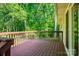 View of the home's stained back deck overlooking a tranquil backyard wooded area at 177 Candlestick Dr, Statesville, NC 28625