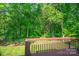 View from the wooden deck overlooking the lush, green backyard with mature trees at 177 Candlestick Dr, Statesville, NC 28625