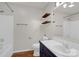 Clean bathroom with wood shelving, white tiling, and sleek fixtures at 177 Candlestick Dr, Statesville, NC 28625