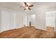 Bright bedroom features wood flooring, a ceiling fan, and ensuite bathroom entrance at 177 Candlestick Dr, Statesville, NC 28625