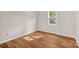 This bedroom features wood-look flooring, a window, and neutral walls at 177 Candlestick Dr, Statesville, NC 28625