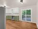 Open kitchen layout with wood-look flooring, with a view to the outdoor deck at 177 Candlestick Dr, Statesville, NC 28625