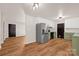 Spacious open-concept kitchen featuring stainless steel refrigerator, hardwood floors and modern lighting at 177 Candlestick Dr, Statesville, NC 28625