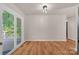 Bright living area features wood-look flooring, a sliding glass door, and neutral walls at 177 Candlestick Dr, Statesville, NC 28625