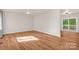 Bright living room with wood flooring, a ceiling fan, and sliding door access to the deck at 177 Candlestick Dr, Statesville, NC 28625