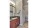 Well-lit bathroom with a wood vanity, granite countertop, and a shower with curtain at 181 Edgewater Rd, Hickory, NC 28601