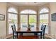 Bright dining area with large windows offering scenic outdoor views and a wooden dining set at 181 Edgewater Rd, Hickory, NC 28601
