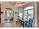 Sunny dining area with a dark wood table set next to a sliding door and three sunny windows at 181 Edgewater Rd, Hickory, NC 28601
