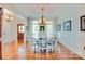 Elegant dining room with hardwood floors, decorative chandelier, and large windows for natural light at 181 Edgewater Rd, Hickory, NC 28601