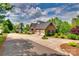 Spacious driveway leads to a brick home with an attached garage and lush landscaping at 181 Edgewater Rd, Hickory, NC 28601