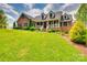 Beautiful brick home featuring a welcoming front porch and lush, green landscaping at 181 Edgewater Rd, Hickory, NC 28601