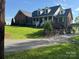 Charming brick home featuring a welcoming front porch and well-manicured lawn, creating a classic and inviting curb appeal at 181 Edgewater Rd, Hickory, NC 28601