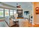 Cozy living room features a stone fireplace, tray ceiling, and large windows for ample light at 181 Edgewater Rd, Hickory, NC 28601