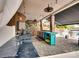 Covered outdoor kitchen and bar area with stone pavers, stainless grill and fridge overlooking a pool area at 181 Edgewater Rd, Hickory, NC 28601