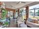 Inviting sunroom with exposed brick, large windows, and comfortable seating at 181 Edgewater Rd, Hickory, NC 28601