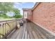 Wooden deck with railing that has potted plants and view of the yard at 182 Meek Rd, Gastonia, NC 28056
