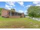 Expansive brick home featuring a screened-in porch and spacious backyard with lush green grass and ample space for recreation at 182 Meek Rd, Gastonia, NC 28056