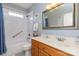 Bathroom with a bathtub with a shower, toilet, and wooden vanity and an oval sink basin at 182 Meek Rd, Gastonia, NC 28056