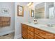 Well-lit bathroom featuring a dual sink vanity with modern faucets and ample storage, enhanced by decorative mirrors at 182 Meek Rd, Gastonia, NC 28056