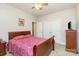 Bedroom with a light-colored walls and carpet, a wooden bed frame, and a double door closet at 182 Meek Rd, Gastonia, NC 28056