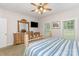 Bright bedroom with a stylish bed, wooden dresser, and large mirror, complemented by two windows that invite natural light at 182 Meek Rd, Gastonia, NC 28056