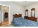Bedroom features a wood dresser, wooden bed frame with blue and white patterned bedding, and neutral paint at 182 Meek Rd, Gastonia, NC 28056