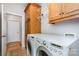 Practical laundry room with washer, dryer, and wooden storage cabinets for efficient organization at 182 Meek Rd, Gastonia, NC 28056